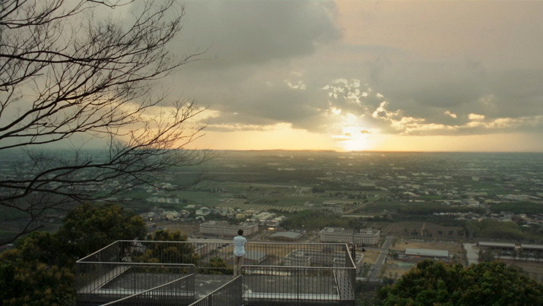 A person looking over a city at sunset in 18×2